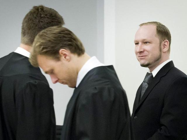 Terror and murder charged Anders Behring Breivik (right) stands with members of his defence team during the morning break of day 6 of the trial in Oslo. AFP Photo: Heiko Junge/Pool