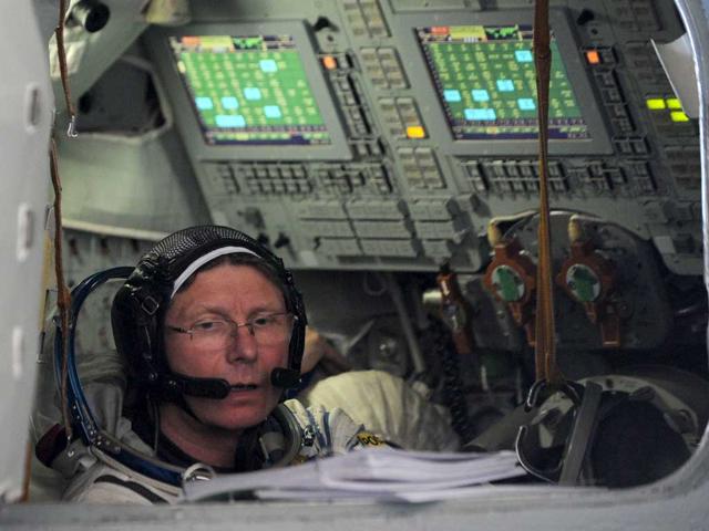 A crew member of the next expedition to the International Space Station (ISS), Russian cosmonaut Gennady Padalka prepares for his final preflight practical examination in a mock-up of a Soyuz TMA space craft at the Cosmonaut Training Centre in Star City, outside Moscow, Russia, on April 24, 2012. The launch of the space crew to ISS is scheduled on May 15, 2012. AFP/ Kirill Kudryavtsev