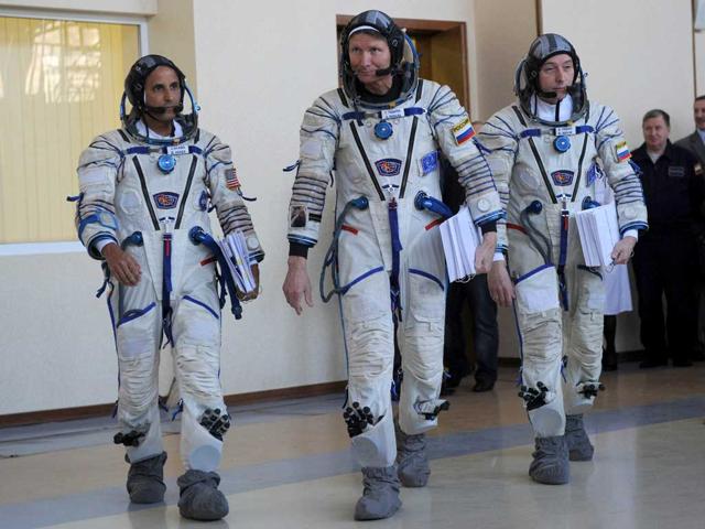 Crew members of the next expedition to the International Space Station (ISS), US astronaut Joseph Acaba (L) with Russian cosmonauts, Gennady Padalka (C) and Sergei Revin (R), arive for their final preflight practical training at the Cosmonaut Training Centre in Star City, outside Moscow, Russia. The launch of the space crew to ISS is scheduled on May 15, 2012. AFP/ Kirill Kudryavtsev