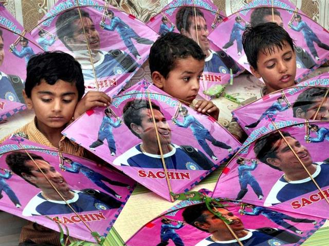 Children hold kites bearing pictures of Sachin Tendulkar on the eve of his birthday in Bikaner. PTI photo