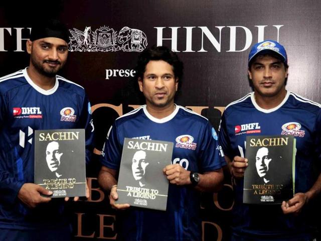 Cricket legend Sachin Tendulkar flanked by Mumbai Indians teammate Harbhajan Singh and coach Robin Singh, releases a book published by The Hindu to commemorate his 100 centuries at a function in Chandigarh, on the eve of his 24th birthday.