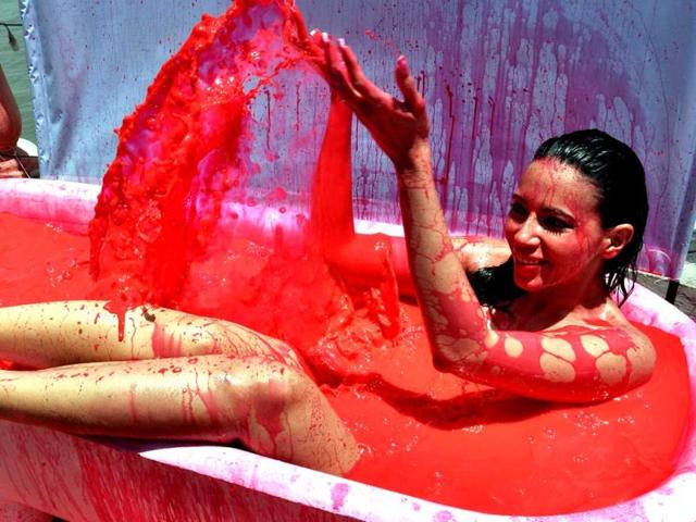 Rozlyn Khan bathes in a bath tub filled with red-coloured water, as part of a protest against the use of animal testing held by People for the Ethical Teatment of Animals (PETA), in Mumbai. (AFP)
