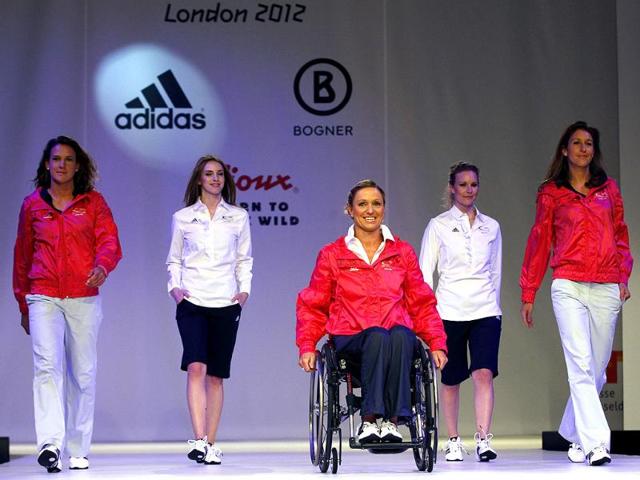 German hockey players Christina Schuetze (L) Janne Mueller Wieland (R) and Paralympics swimmer Kirsten Bruhn present the official uniforms of the German Olympic team for the 2012 Olympic Games in Duesseldorf. (Reuters/Ina Fassbender)