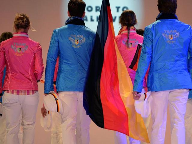 Members of the German Olympic team for London 2012 and models walk down the catwalk during the press presentation of the official team clothes at the fairground in Duesseldorf, Western Germany. (AFP photo/Patrik Stollarz)
