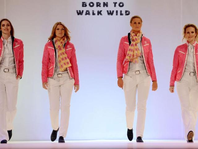 Members of the German Olympic team for London 2012 and models walk down the catwalk during the press presentation of the official team clothes on the fairground in Duesseldorf , Western Germany. (AFP photo/Patrik Stollarz)