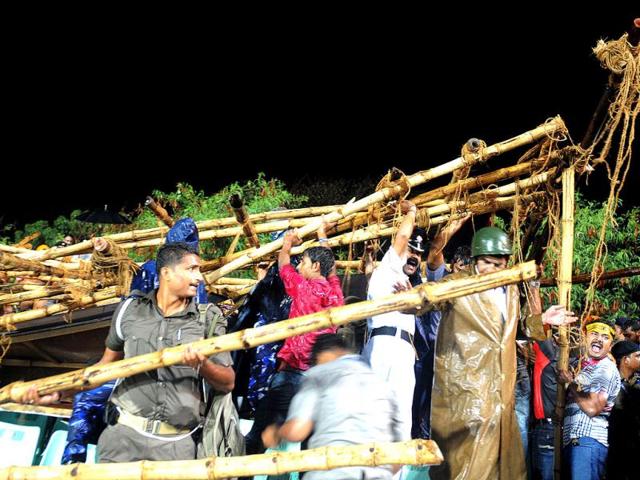 Rescue workers attempt to remove a damaged display board on a stand at the IPL T20 cricket match in Kolkata. (AFP Photo/STR)