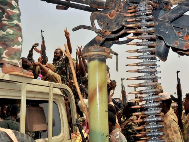 Sudanese soldiers cheer on a military vehicle in the oil town of Heglig bordering with South Sudan. AFP Photo/Ebrahim Hamid
