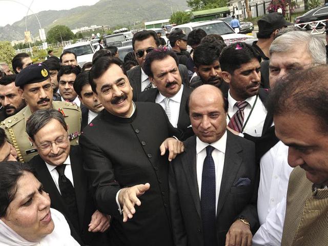 Pak PM Yousuf Raza Gilani makes his way to the Supreme Court for a hearing in Islamabad. AP Photo/BK Bangash