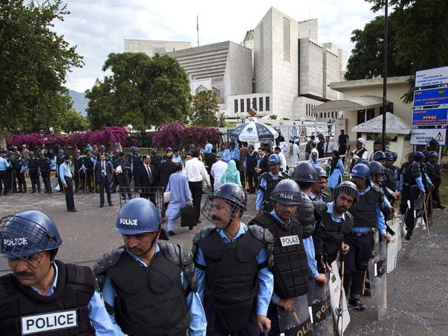 Policemen in riot-gears cordon off the Supreme court as Pak PM Yousuf Raza Gilani, unseen, appears for a hearing in Islamabad. AP Photo/BK Bangash