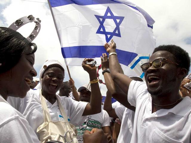 Christians Nigerians migrant workers, members of the "Redeemed Christian of Good," dance during Israel's 64th Independence Day anniversary celebrations in the Mediterranean city of Tel Aviv. Israel's first Prime Minister David Ben-Gurion declared the existence of the State of Israel in Tel Aviv 64 years ago, ending the British mandate. AFP/Jack Guez