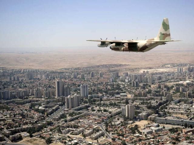 A Hercules C-130 Israeli military transport plane flies over Beer Sheva, south of Hebron, during a military display to mark the 64th anniversary of Israel's Independence. AFP/David Buimovitch