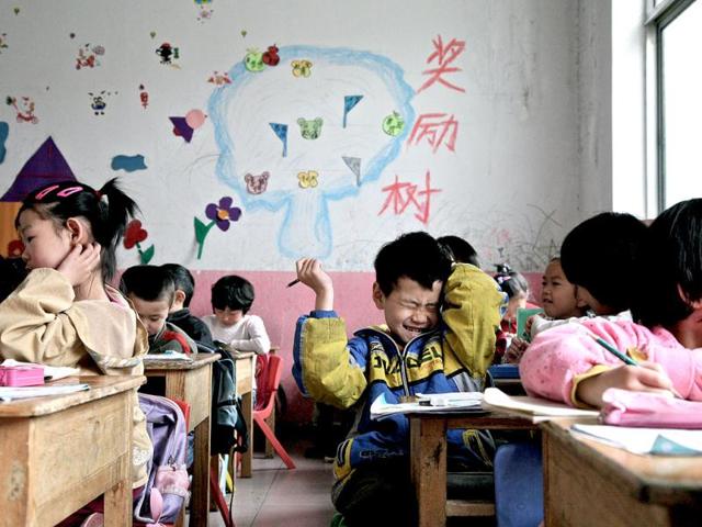 Young Chinese children attend a kindergarten set up for migrant workers, which is marked for demolition, in Beijing. AFP Photo