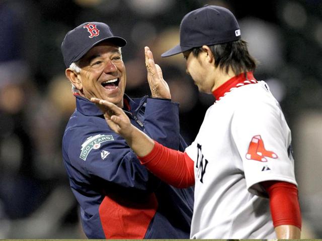 Boston Red Sox manager Bobby Valentine (L) celebrates with his relief pitcher Junichi Tazawa after they beat the Chicago White Sox 10-3 in their MLB baseball game in Chicago, Illinois. Reuters/Jeff Haynes