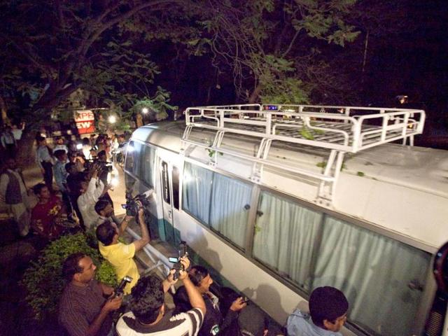 Members of the media surround the vehicle carrying the family members of Osama bin Laden as they leave for the airport from a house in Islamabad. Reuters