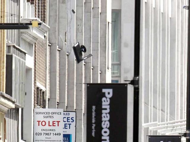 Computer equipment falls from an office window (top L) in Tottenham Court Road in central London. Reuters/Luke MacGregor