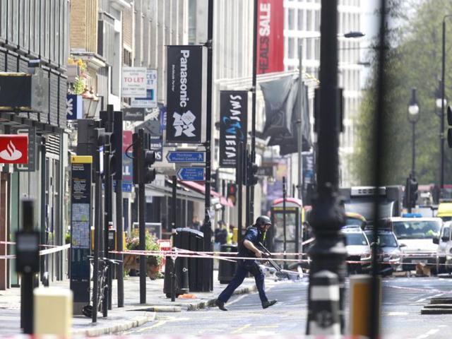 An armed police officer runs on the Tottenham Court Road in central London. Reuters/Luke MacGregor