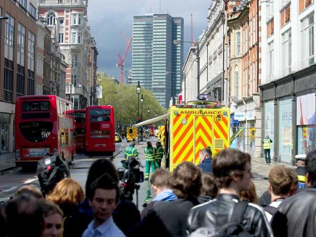 People gather on Tottenham Court Road in central London as police seal off the street. AFP Photo/Daniel Sorabji