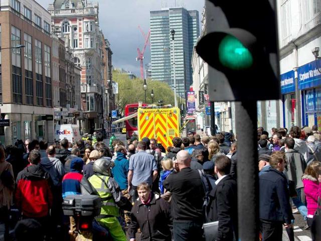Police officials seal off Tottenham Court Road amid reports of an armed man causing a disturbance. AFP Photo/Daniel Sorabji