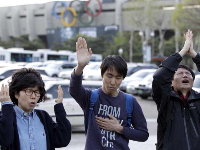 Christians pray as they call for the cancellation of a concert by US pop star Lady Gaga just outside the venue in Seoul, South Korea. AP/Lee Jin-man
