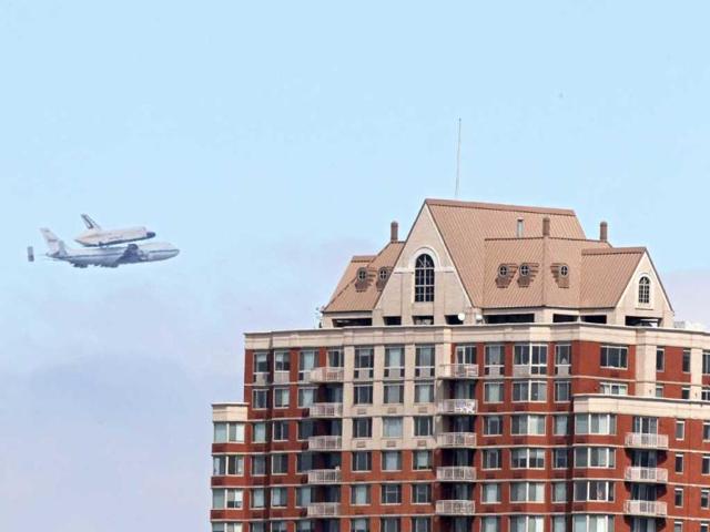 Space shuttle Enterprise, mounted atop a 747 shuttle carrier aircraft, flies past the Jersey City skyline prior to landing at John F Kennedy International Airport in New York City. Enterprise, which was flown from Washington, DC, will eventually be put on permanent display at the Intrepid Sea, Air and Space Museum. Michael Heiman/Getty Images/AFP
