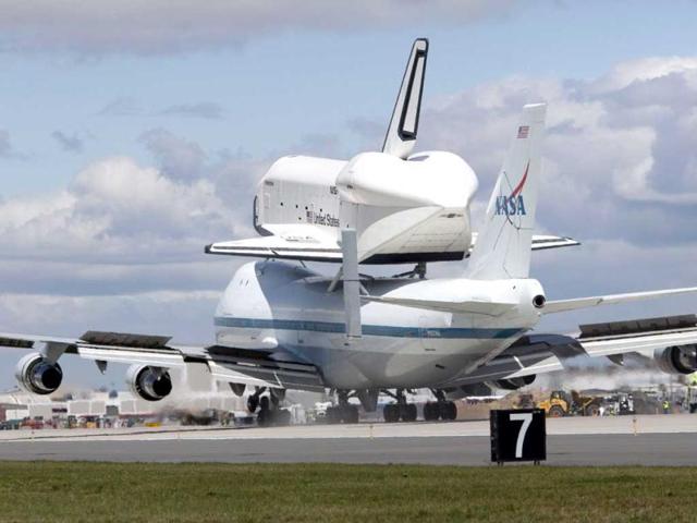 Space shuttle Enterprise, mounted atop a 747 shuttle carrier aircraft, lands at John F Kennedy International Airport in the Queens borough of New York City. Enterprise, which was flown from Washington, DC, will eventually be put on permanent display at the Intrepid Sea, Air and Space Museum. Allison Joyce/Getty Images/AFP