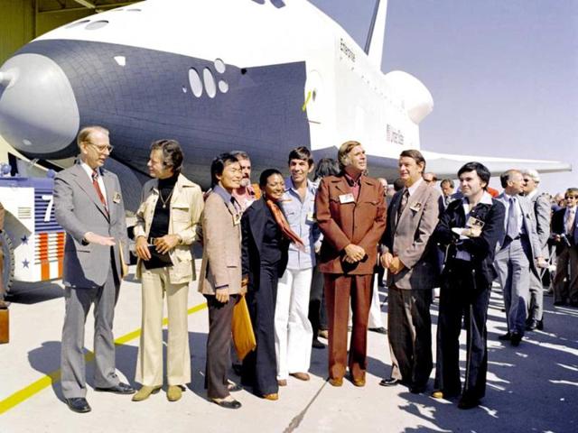 Star Trek television cast members attend the roll out of the Space Shuttle Enterprise at the Palmdale manufacturing facilities in this NASA handout photo dated September 17, 1976. From left to right: NASA Administrator Dr. James D. Fletcher, DeForest Kelley (Dr. "Bones" McCoy), George Takei (Mr. Sulu), James Doohan (Mr. Scott), Nichelle Nichols (Lt. Uhura), Leonard Nimoy (Mr. Spock), Gene Rodenberry and Walter Koenig (Ensign Pavel Chekov). The Enterprise officially arrived in New York on April 27 to be placed in the Intrepid Sea, Air and Space Museum. REUTERS/NASA/Handout