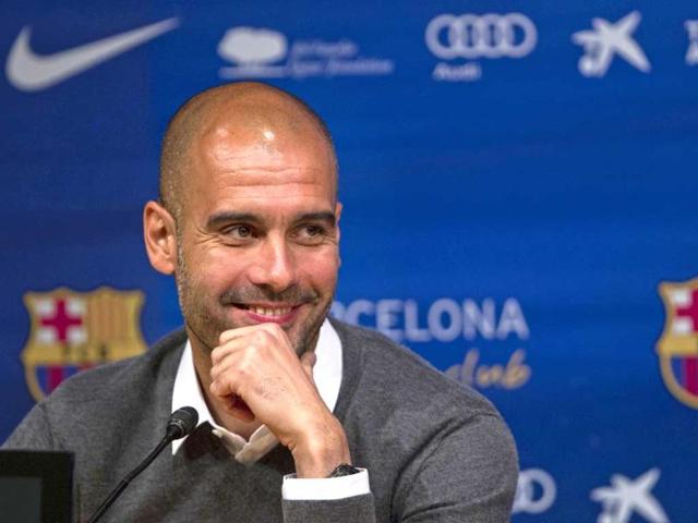 Barcelona's coach Pep Guardiola smiles during a press conference where he announced his resignation. AP Photo/Emilio Morenatti