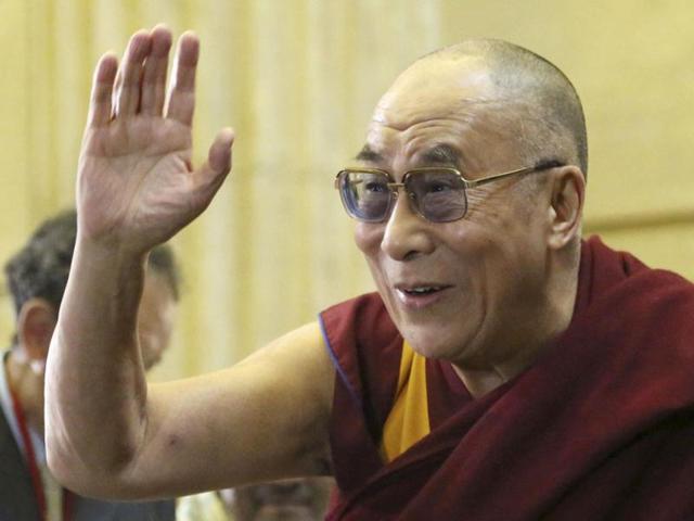 Tibet's spiritual leader, the Dalai Lama, waves as he arrives at the World Parliamentarians' Conventions on Tibet conference in Ottawa. Reuters