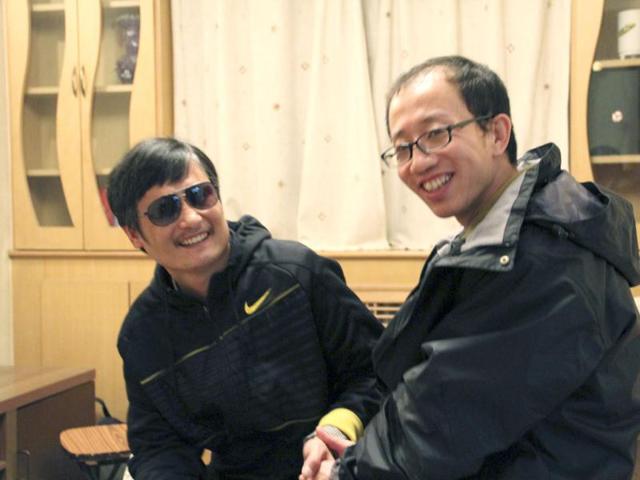 This undated photo shows outspoken government critic Hu Jia (R) sharing a light moment with blind lawyer Chen Guangcheng after his escape, at an undisclosed location in Beijing. AFP