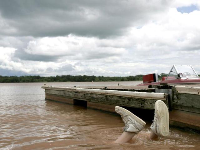 Colby Deck dives underwater to noodle for catfish in Pauls Valley, Oklahoma. Noodling is the sport of fishing by hand instead of with a rod and reel. Reuters/Jessica Rinaldi