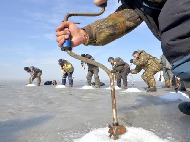 Fishermen drill ice-holes during a competition in Russia's far eastern city of Vladivostok. Reuters/Yuri Maltsev
