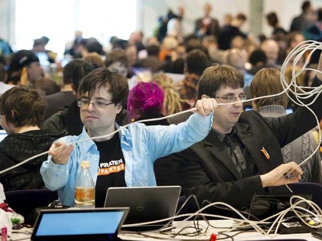 Members of the Pirate Party prepare network cables for their party convention in Neumuenster, northern Germany. AP Photo/dapd, Clemens Bilan