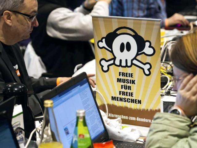 Members of the Pirate Party sit next to a poster reading "Free Music for Free People" during their party convention in Neumuenster, northern Germany. AP Photo/dapd, Clemens Bilan