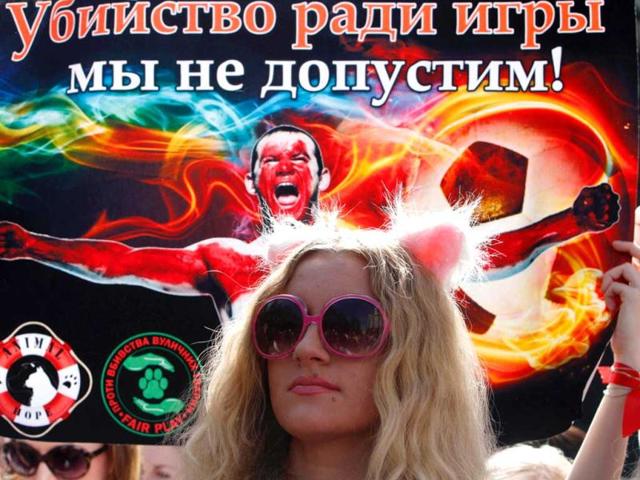 A woman holds a placard reading 'We will prevent killing for play!' during the 'Fair Play For Strays' demonstration to speak out for the rights of stray animals in Kiev. Reuters photo