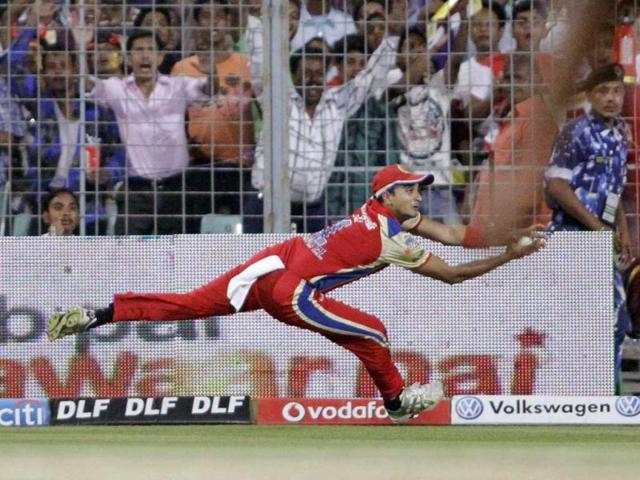 Royal Challengers Bangalore's Harshal Patel dives unsuccessfully to hold a catch during an Indian Premier League cricket match against Kolkata Knight Riders, in Kolkata. AP/Bikas Das