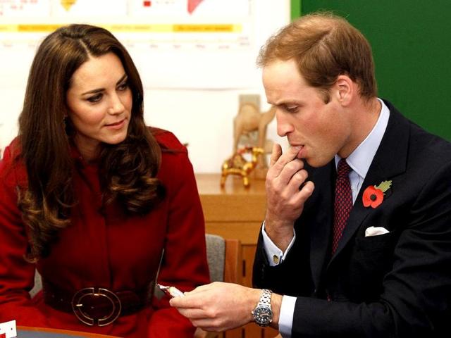 Britain's Prince William (R), watched by his wife Catherine, Duchess of Cambridge, tastes a high energy paste used to treat severe malnutrition during a visit to the UNICEF emergency supply centre in Copenhagen, Denmark. (Reuters/Phil Noble)