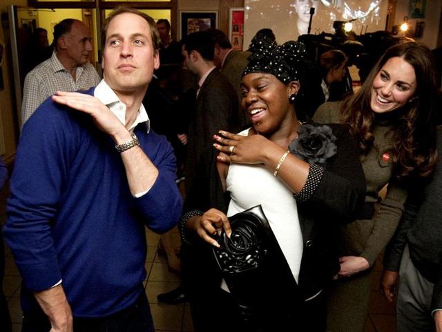 Britain's Prince William dances with Vanessa Boateng (C) as his wife Catherine, Duchess of Cambridge (R) looks on during a reception at Centrepoint's Camberwell Foyer in London. (Reuters/Ben Stansall/POOL)