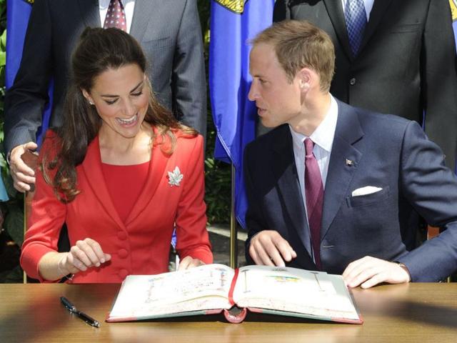 Britain's Prince William and his wife Catherine, Duchess of Cambridge, react during a signing ceremony at the Calgary Zoo in Calgary, Alberta. (Reuters/Todd Korol)