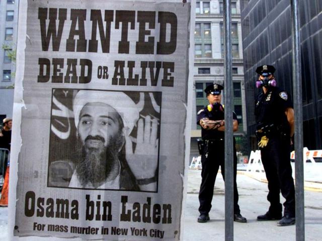New York police stand near a wanted poster printed by on a full page of a New York newspaper for Saudi-born militant Osama bin Laden in the financial district of New York, in this file photo from September 18, 2001, post the attack on the Twin Towers. (Reuters)