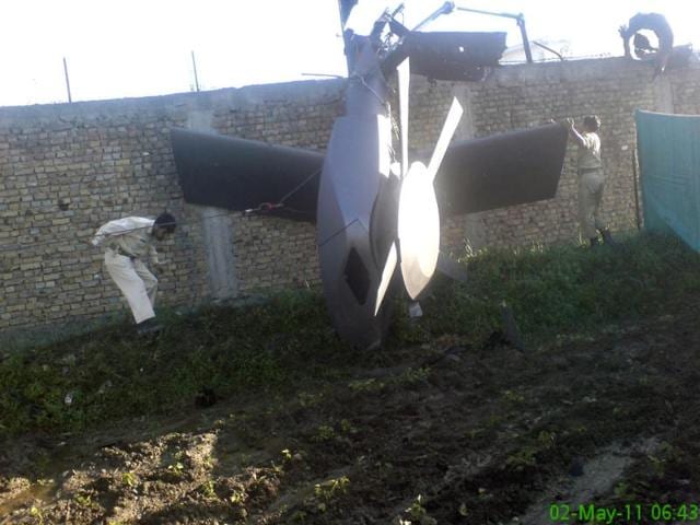 Part of a damaged helicopter is seen lying near the compound after US Navy SEAL commandos killed al Qaeda leader Osama bin Laden in Abbottabad. (Reuters)