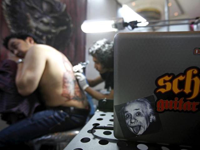 A picture of Albert Einstein is seen as a man gets a tattoo during the 2nd International Nepal Tattoo Convention in Kathmandu. Reuters/Navesh Chitrakar