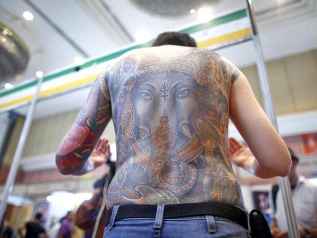 A man flaunts his tattoo of Hindu God Ganesha during the second International Tattoo Convention in Kathmandu. AP Photo/Niranjan Shrestha