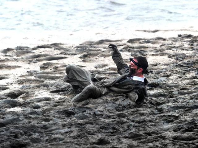 A competitor falls down as he takes part in the Maldon Mud Race in Essex. AFP/Carl Court