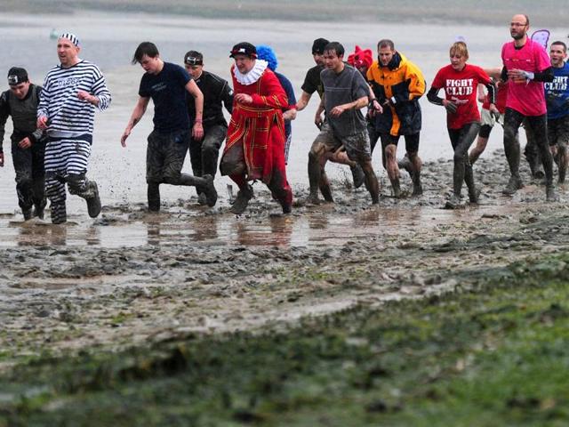 Competitors run during the Maldon Mud Race in Maldon, Essex. AFP/Carl Court