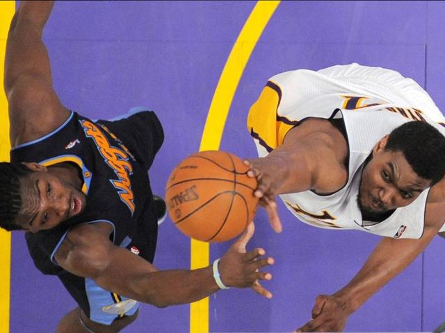 Los Angeles Lakers center Andrew Bynum, right, swats a shot away a shot by Denver Nuggets forward Kenneth Faried during the second half of an NBA first-round playoff basketball game, in Los Angeles. The Lakers won 103-88. (AP Photo)