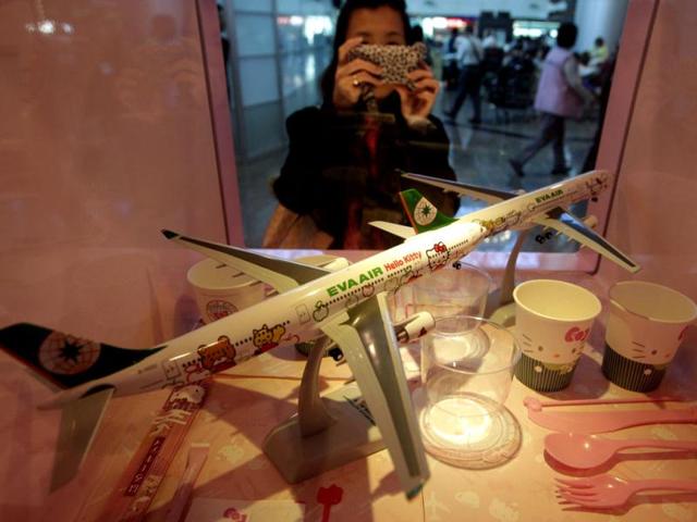 A passenger takes pictures of Eva Airlines' Hello Kitty-themed products displayed in Taoyuan International Airport, northern Taiwan. Reuters photo/Pichi Chuang