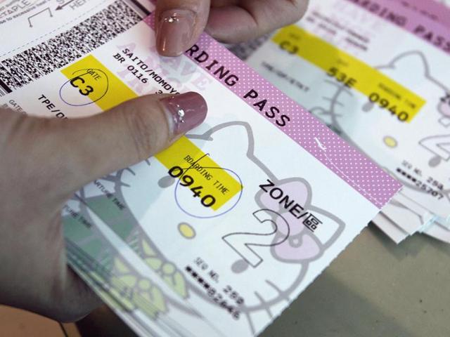An Eva Airlines ground crew counts Hello Kitty-themed boarding passes in Taoyuan International Airport, northern Taiwan. Reuters photo/Pichi Chuang