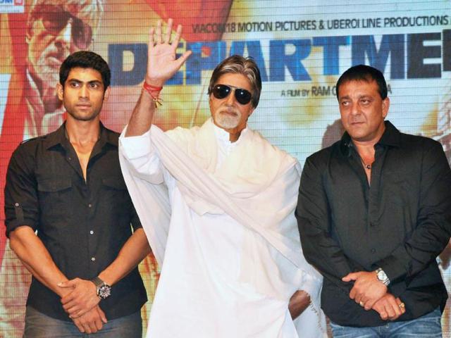 Amitabh Bachchan waves at the media as Sanjay and Rana look on.