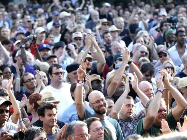 People in the crowd cheer at a sunrise concert marking International Jazz Day in New Orleans. AP Photo/Gerald Herbert