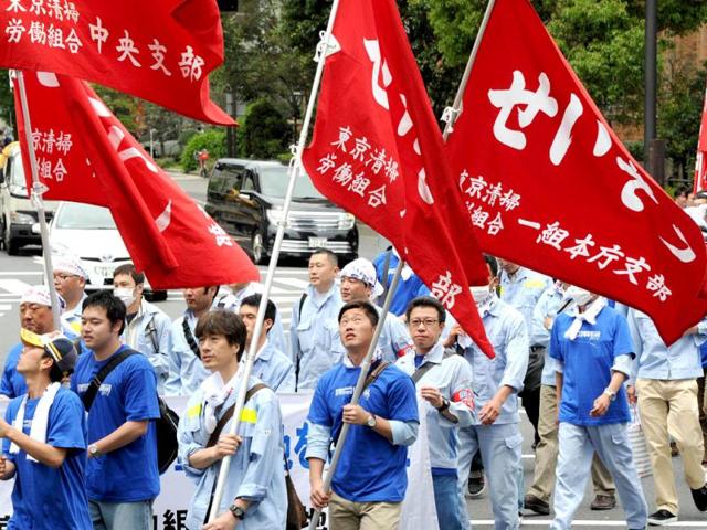 People march on the street as they hold banners during a May Day demonstration on May 1, 2012. Several thousand people took part in the demonstration following a rally at a park. (AFP Photo)